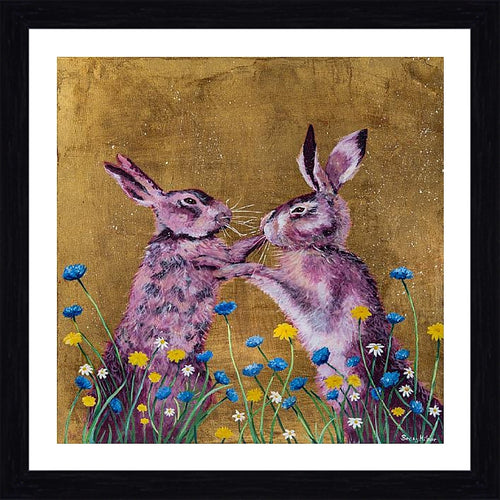 A framed and mounted print featuring two stylized hares boxing, set against a golden background with colorful flowers at the bottom.