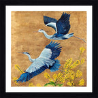 Framed art print featuring two blue and white herons flying over yellow flowers on a textured gold background, enclosed in a white mat and a black frame.