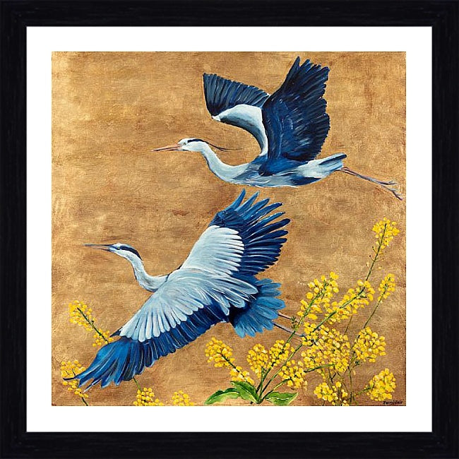 Framed art print featuring two blue and white herons flying over yellow flowers on a textured gold background, enclosed in a white mat and a black frame.